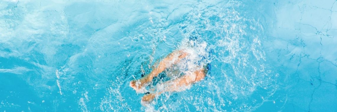 person swimming in blue water